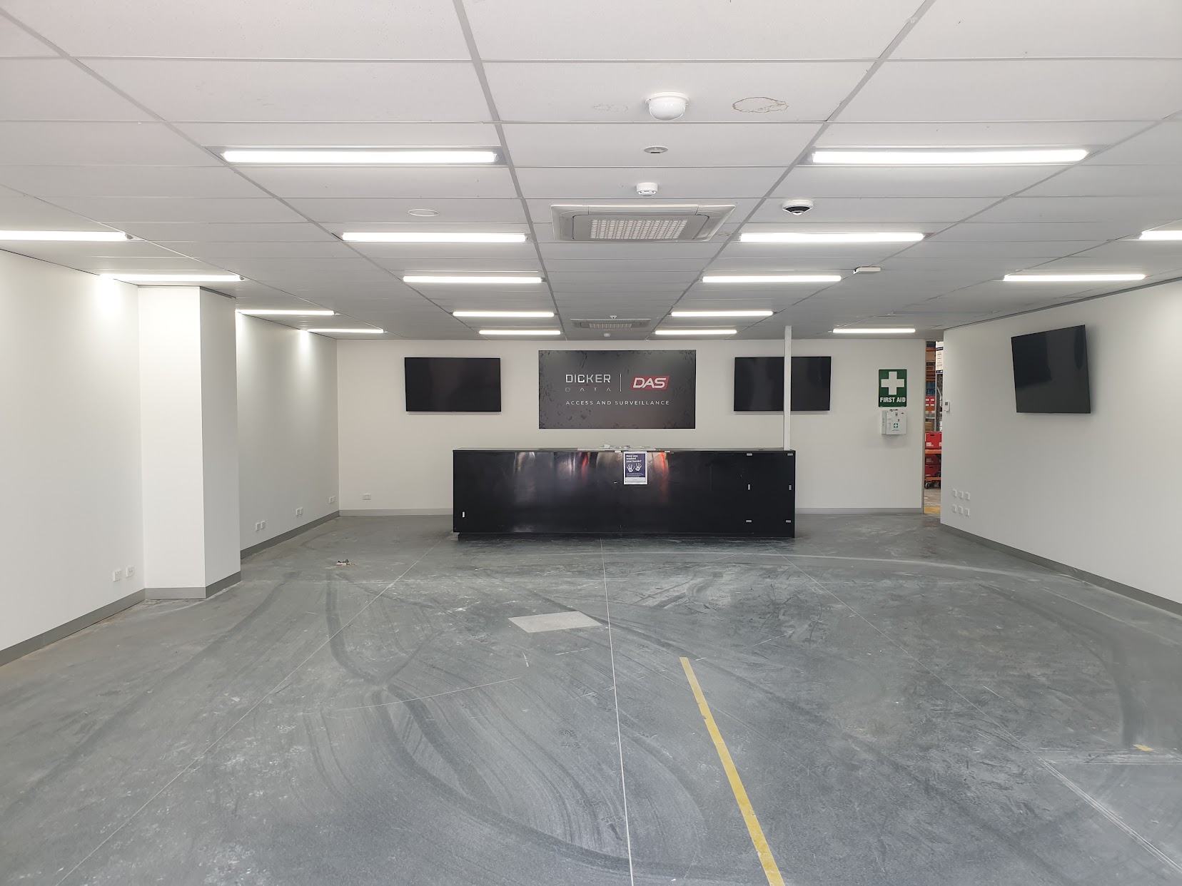 Commercial reception area after interior painting, with finished white walls and ceiling